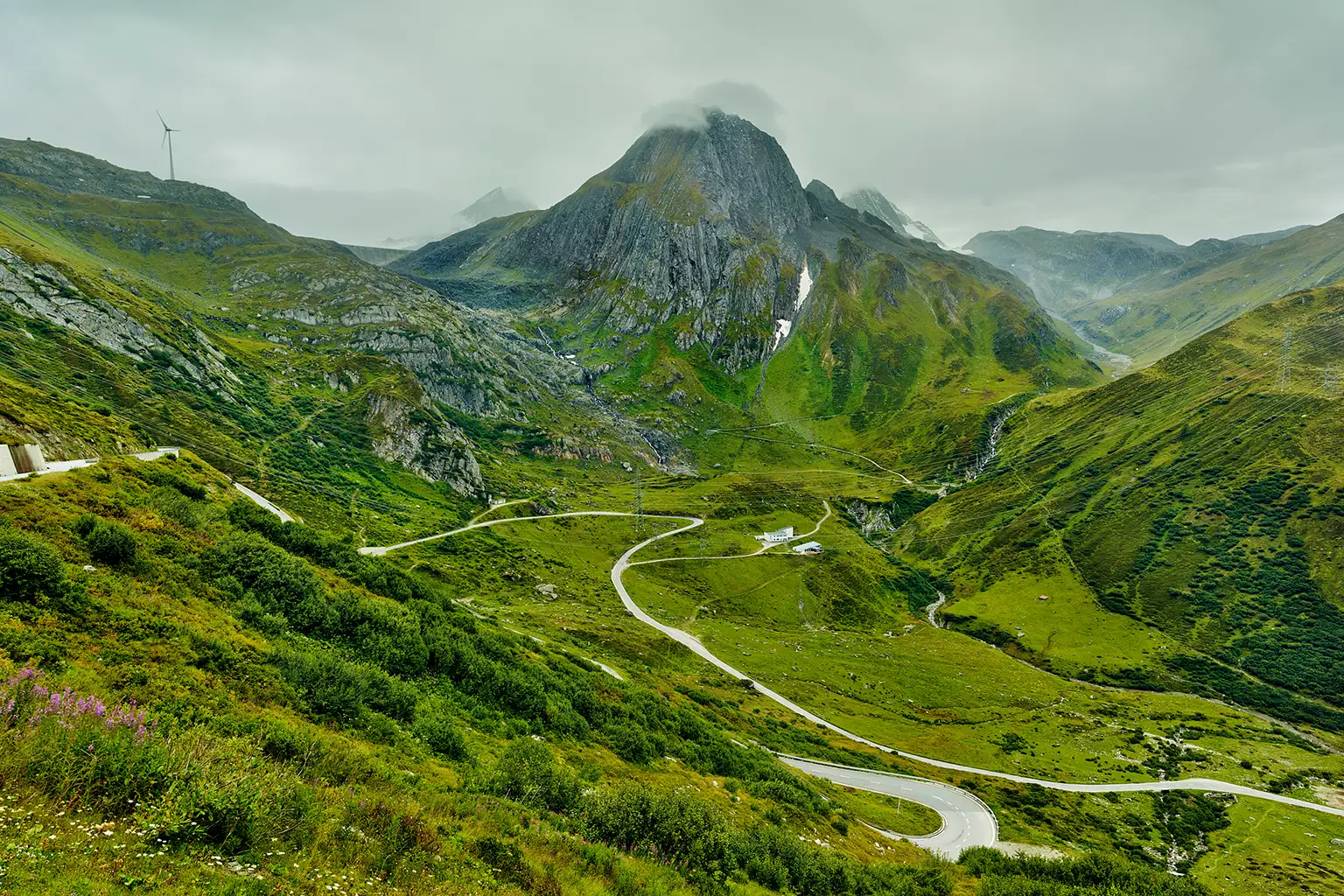 Road leading up the western ramp of the Nufenen Pass and the Fülhorn mountain in Switzerland