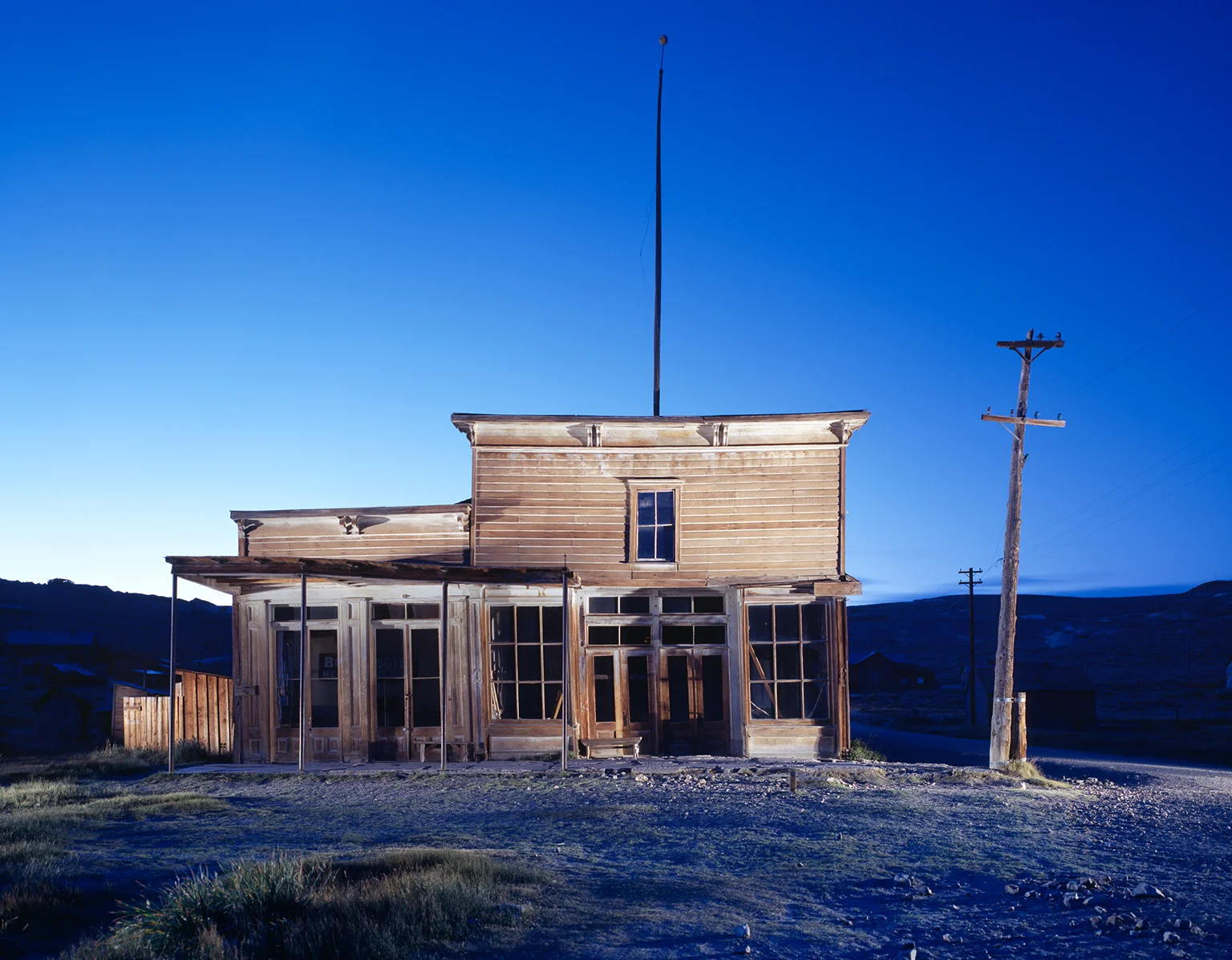 Holz Gebäude des Wheaton Hollis Hotel in der Dämmerung in der Ghost Town Bodie