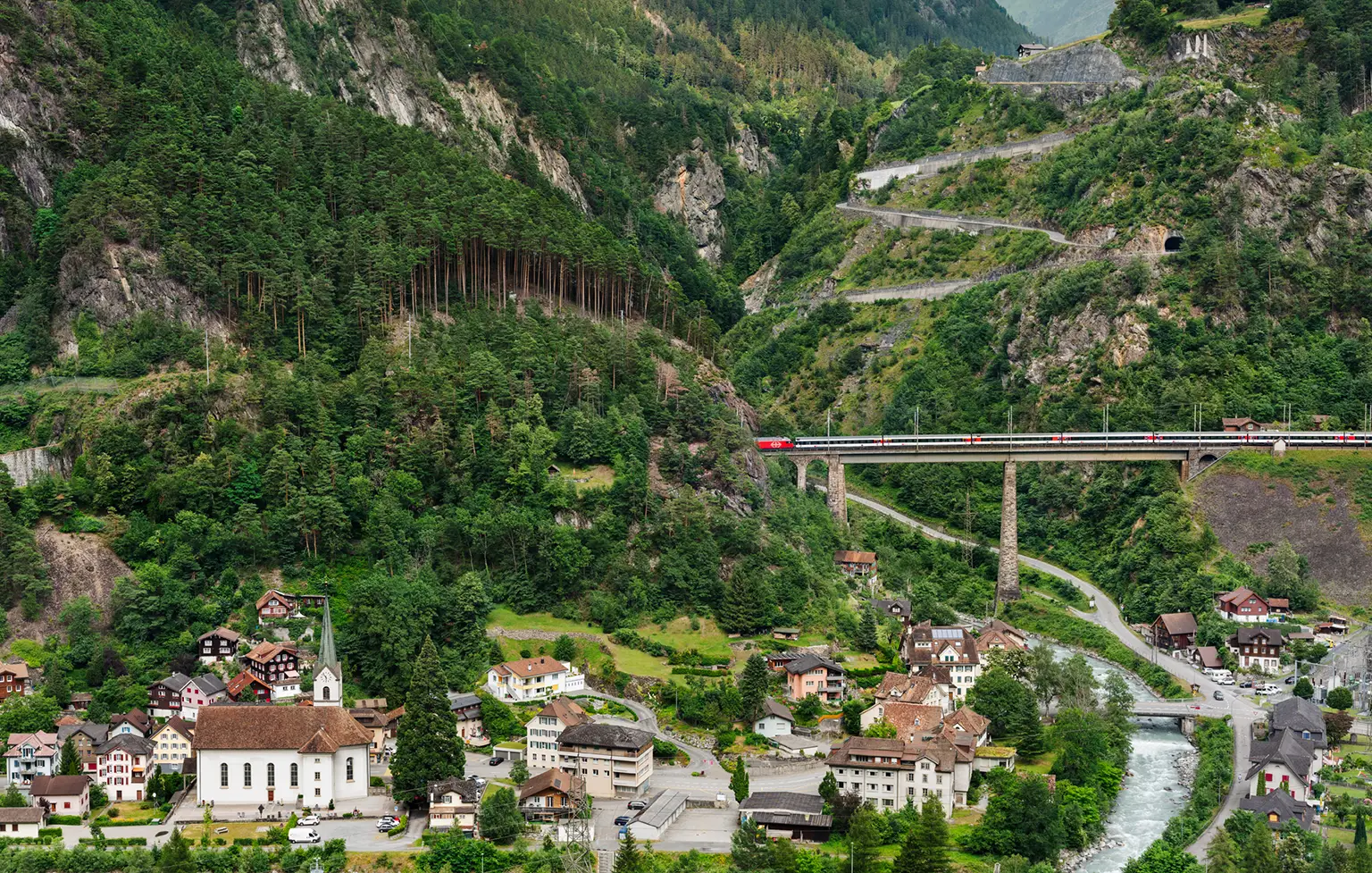 A train on the Gotthard Railway line at the Chärstelenbach Bridge in Amsteg 