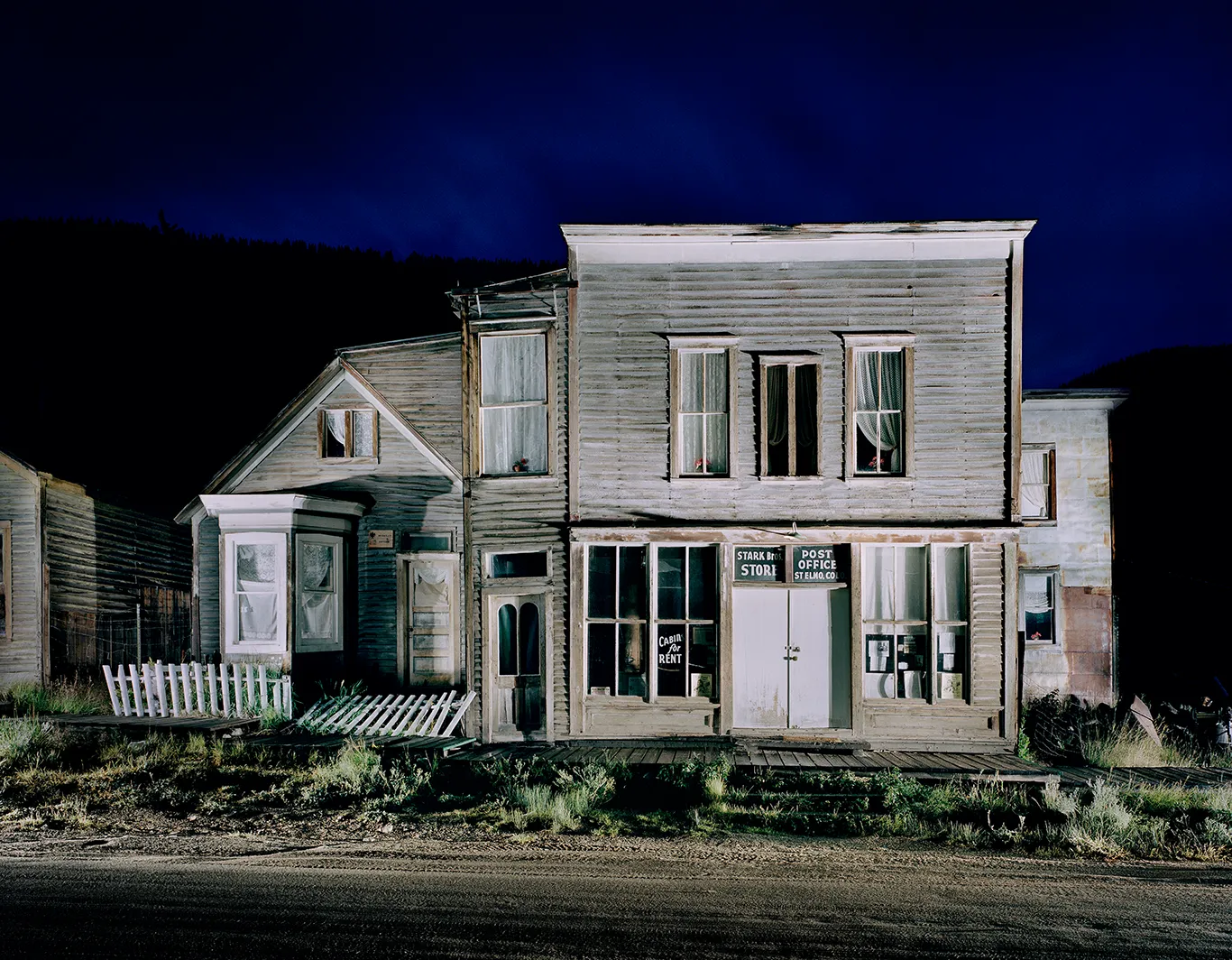 The historic timber façade of the Home Comfort Hotel in the ghost town of St. Elmo, Colorado, featuring Western-style windows and a veranda