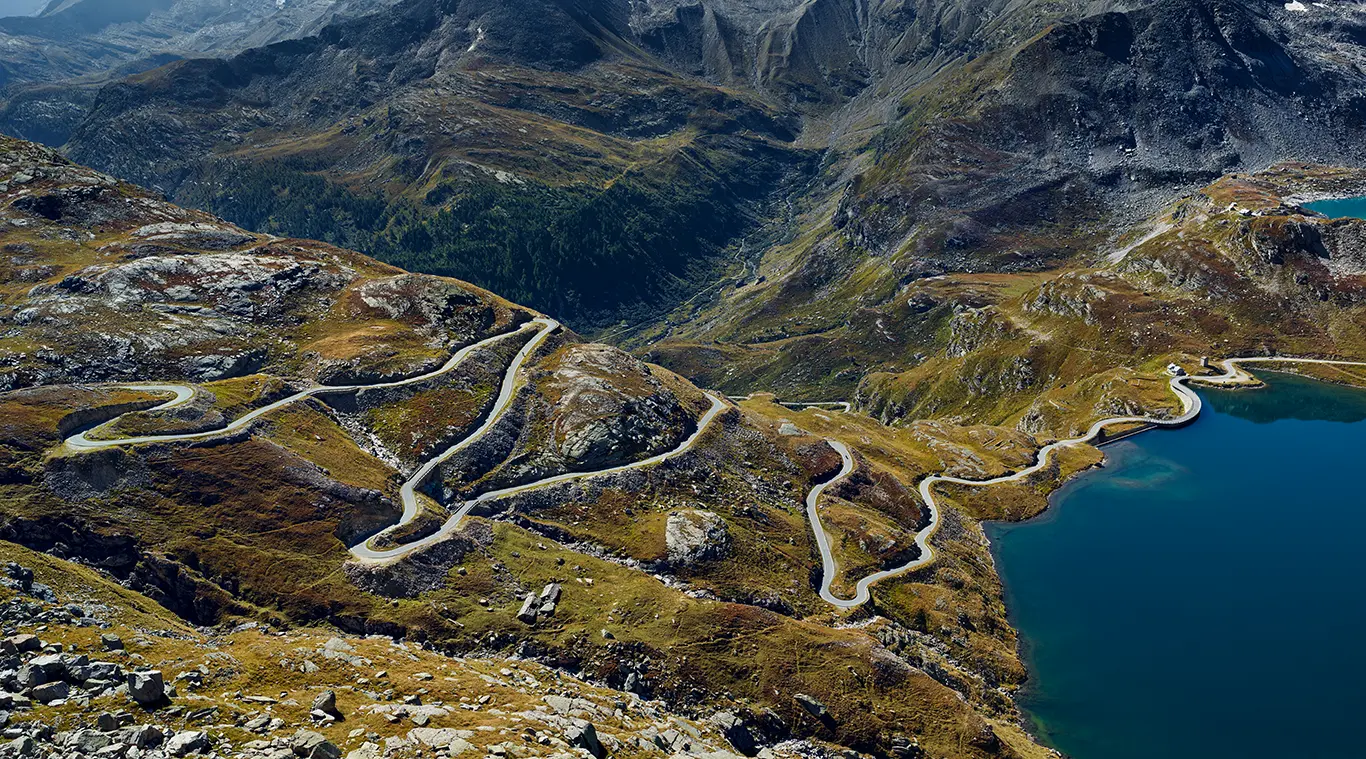 kurvenreiche Südrampe des Colle del Nivolet in den Grajischen Alpen. Die Auffahrt zum Nivolet gilt als eine der anspruchsvollsten Radstrecken Italiens, mit dem größten Höhenunterschied jeder asphaltierten Passstraße des Landes.